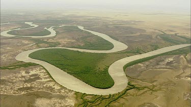 Aerial Meandering river zigzags across landscape.