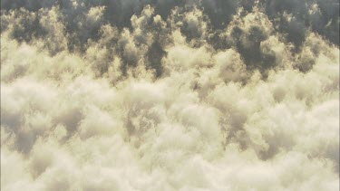 Aerial clouds. Morning Glory cloud breaking up and disintegrating into small fluffy white clouds