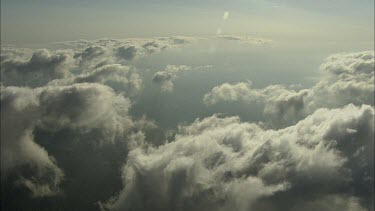 Aerial clouds. Morning Glory cloud breaking up and disintegrating into small fluffy white clouds. Blue sky beyond.