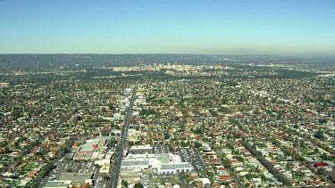 Adelaide aerial approach to city over suburbs.