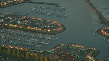 South Australia, Adelaide Marina with yachts and luzury homes on banks of Bay.