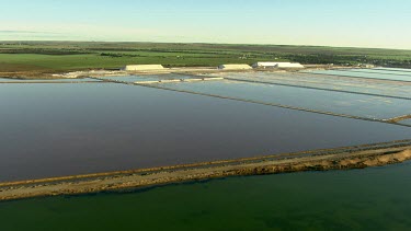 Salt mining and salt processing, manufacture Cheetham salt. Great Australian Bight. Salt produced by solar evaporation from saline or brine waters.  Small triangular mountains of salt scrapped up.