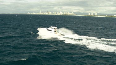 Gold Coast Surfers Paradise with speedboat in foreground over ocean.