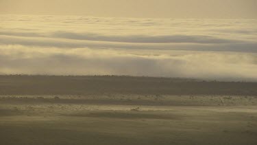 Morning Glory cloud low over land. Sunrise