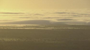 Morning Glory cloud low over land. Sunrise