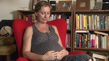 Pregnant woman reads to her unborn baby