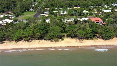 Aerial coastal town mission beach, Tropical North Queensland with coastal rainforest in background.