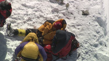 Aerial of Mount Everest:  Climbers looking after troubled climber.