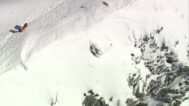 Aerial of Mount Everest: Two climber holding and supporting other climber while walking.