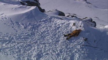 Aerial of Mount Everest: Climber in laying in snow.