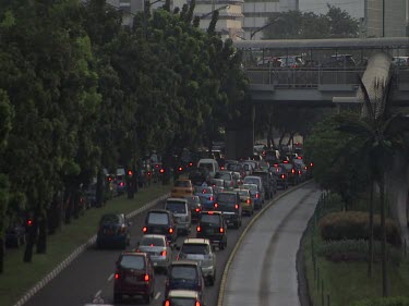 Jakarta evening. Dusk. Traffic. Cars driving. Rush hour