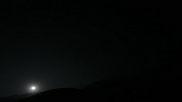 Time lapse of a night in the mountains. Full moon rising