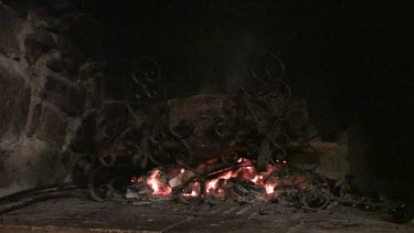 Wood catching fire and burning in a fireplace