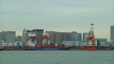 Unloading a freight ship in Odaiba harbour, Tokyo