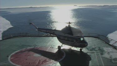 Helicopter taking off from the back of an icebreaker in the Weddell Sea, Antarctica