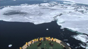 High angle looking down on prow of Russian ice-breaker sailing and breaking the ice in the Weddell Sea, Antarctica. The ice cracks and drifts apart.