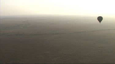 Aerial view of Serengeti National Park with hot air balloon.