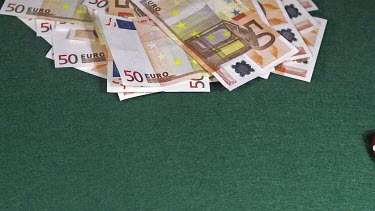 Red Dice rolling against Green background with 50 euros Money, slow motion