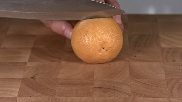 Orange being Cut with a Knife, Slow Motion
