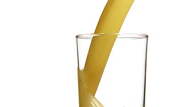 Orange Juice being poured into Glass against White Background, Slow Motion