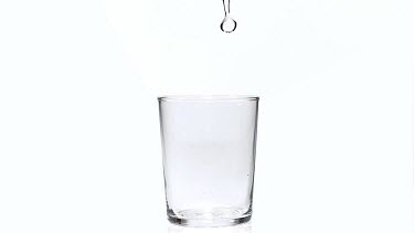 CM0033-GLHD-0049839 Water being poured into Glass against White Background, Slow Motion