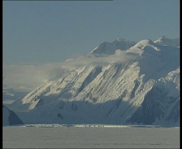 Snowy mountain with low cloud