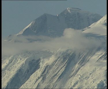 Snowy mountain with low cloud