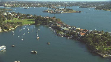 Sydney Inner West suburbs and Cockatoo Island. Harbour with luxury mansion homes with waterfront access. Yachts and boats.