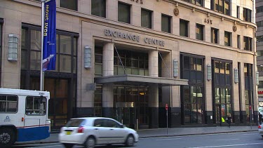 Exterior shot WS Australian Securities Exchange Stock Exchange ASX.  Exchange Square with Sydney buses and cars driving past. 18 Bridge Street Sydney.