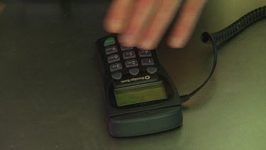 Man's hand close up. He swipes credit card and keys in pin number.