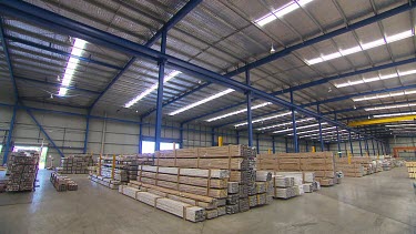 Wide Shot building construction supplies in a warehouse or factory.