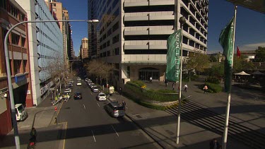 Busy central Sydney street with work people, cars and taxis.