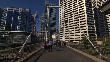 Pedestrian bridge at Darling Harbour, Sydney with Sydney Tower (Centrepoint) in background. Skyscrapers.