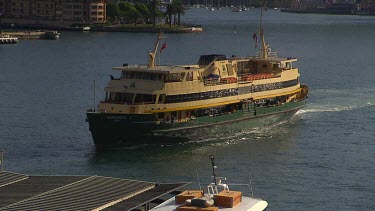 Sydney Harbour Ferry with passengers docking at Circular Quay in the City. First Shot