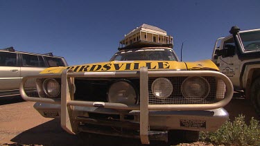 Scale model of Birdsville Hotel on top of yellow cab (taxi).
