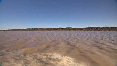 Tracking over flooded waters of Diamantina River, outback desert river in flood.