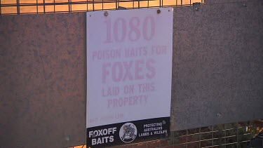 Sign on Bilby fence says "Poison baits for Foxes laid on this property, protecting Australian lambs and wildlife"