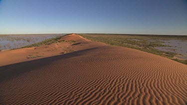 Simpson Desert in flood. Big Red sand dune. WS. Ripples of sand on sand dune from wind.