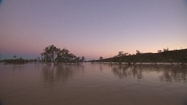 Simpson Desert in flood. Sun setting