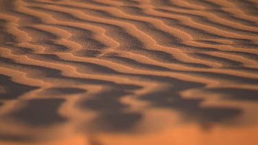 Pull focus shift focus close up of ripples of sand, sand dune desert.