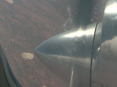 Desert below, close up of propeller.  Lake Eyre, Simpson Desert flooded, patches of green