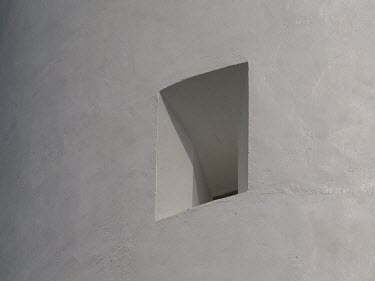 Close up of small square window in white wall of Split Point lighthouse