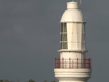 Signal room Cape Otway lighthouse, weathervane. Woman walks down path towards lighthouse.