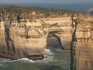 Large sea arch called Island Arch. Shows erosion of limestone by waves, ocean.
