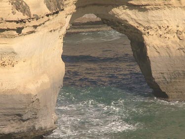 Large sea arch called Island Arch. Shows erosion of limestone by waves, ocean.