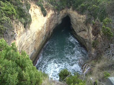 Sea cave eroding in base of limestone cliffs. Few shots