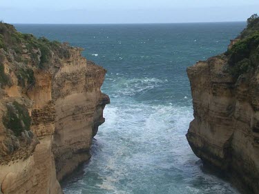 Loch Ard Gorge. Cliffs. Razorback, a ridge of stone sticking straight out of the sea. Layers and patterning in the rock