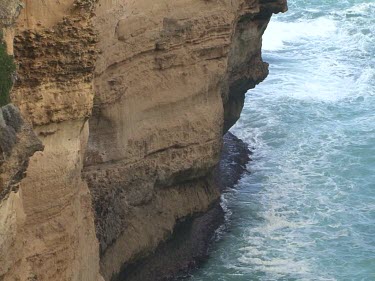 Loch Ard Gorge. Cliffs. Razorback, a ridge of stone sticking straight out of the sea. Layers and patterning in the rock