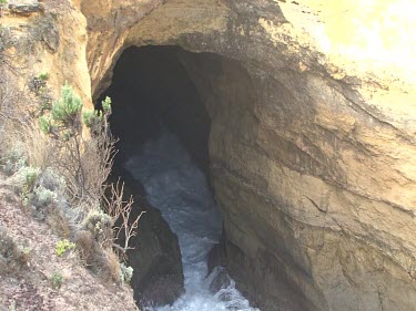 Sea cave eroding in base of limestone cliffs. Few shots