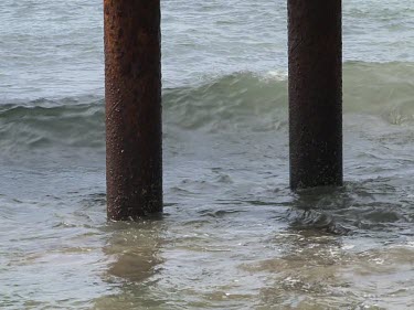 Piling structure of pier. Waves crashing, rusting and erosion. Lorne Victoria.